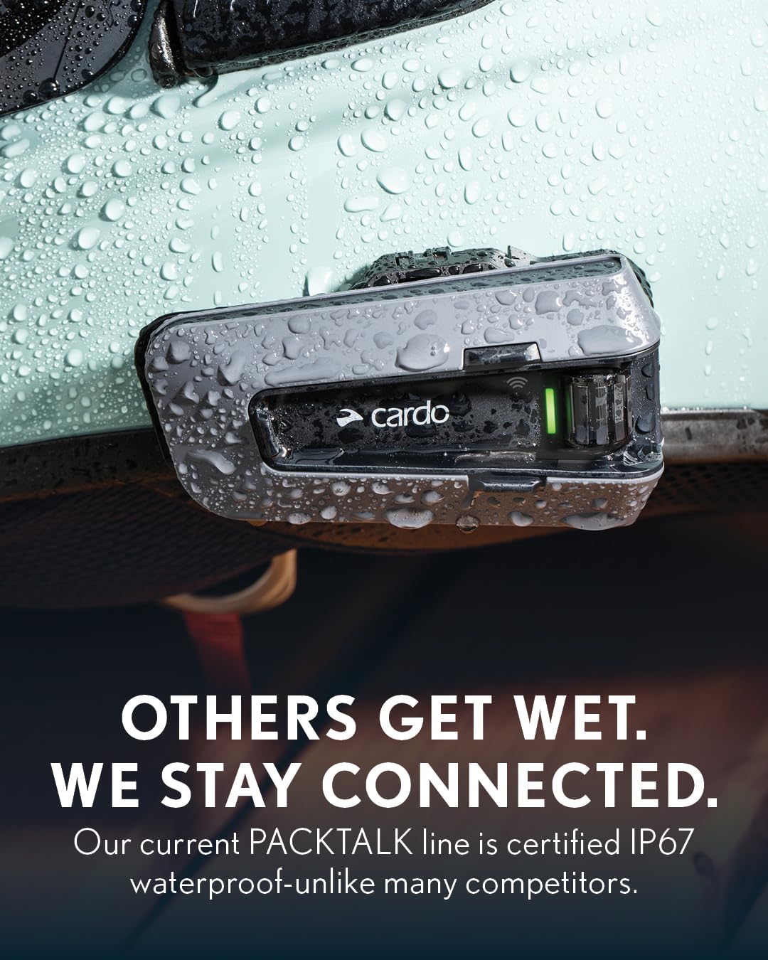 Cardo PACKTALK PRO beside a ruler for compact size scale comparison and portability benefit
