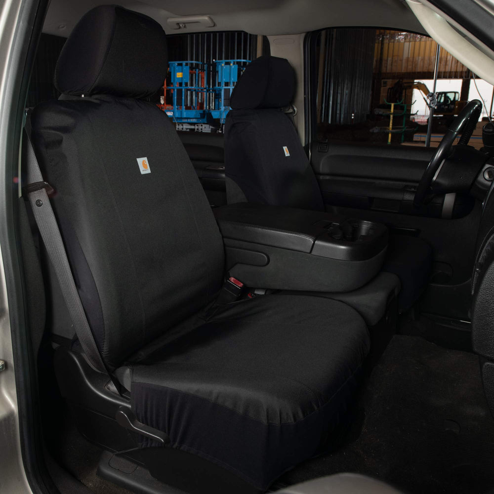 Carhartt seat cover beside tape measure showing fit dimensions