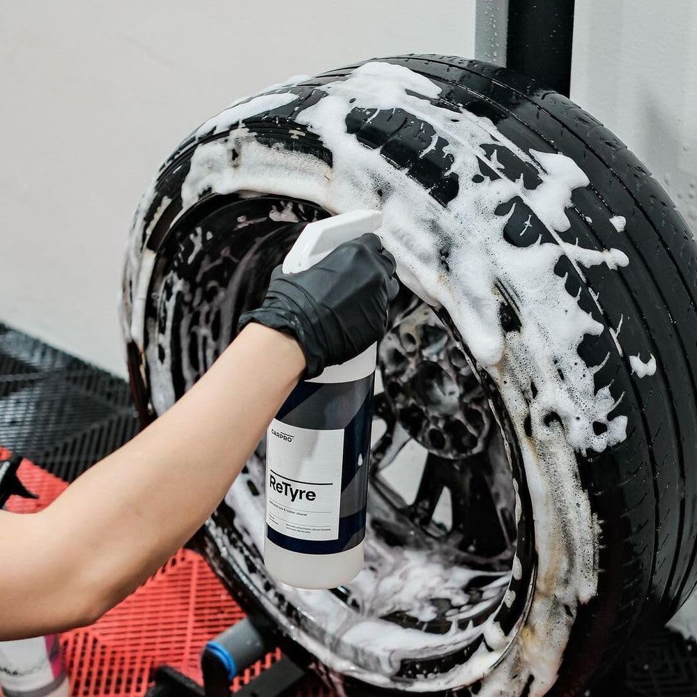CARPRO ReTyre being sprayed onto a tire to remove road film effectively