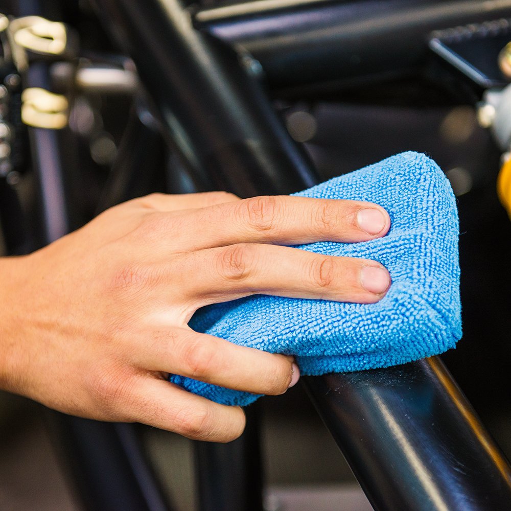 Chemical Guys pad spreading car wax on paint for even, glossy coverage