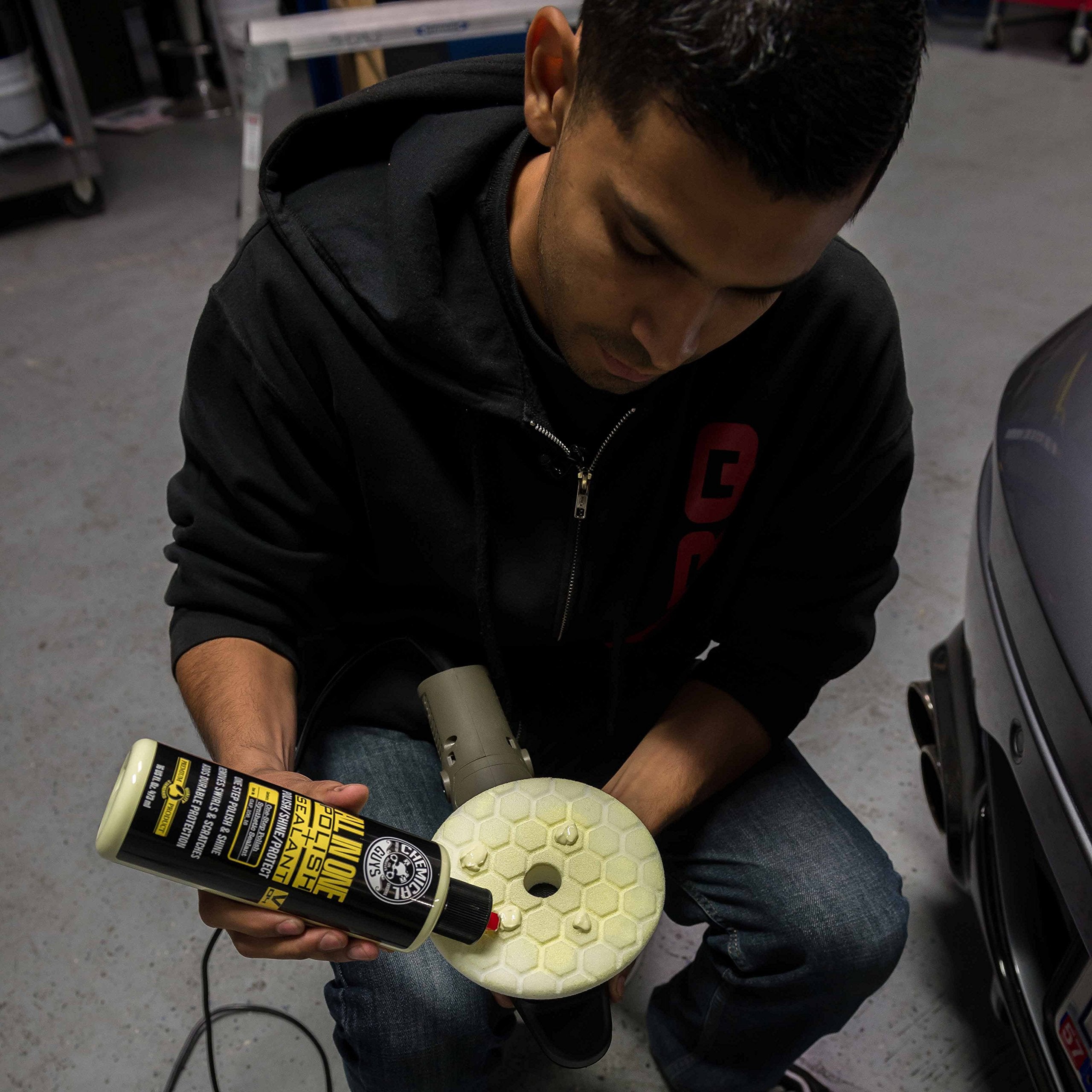 Chemical Guys bottle resting on a car hood conveying professional finish and showroom shine