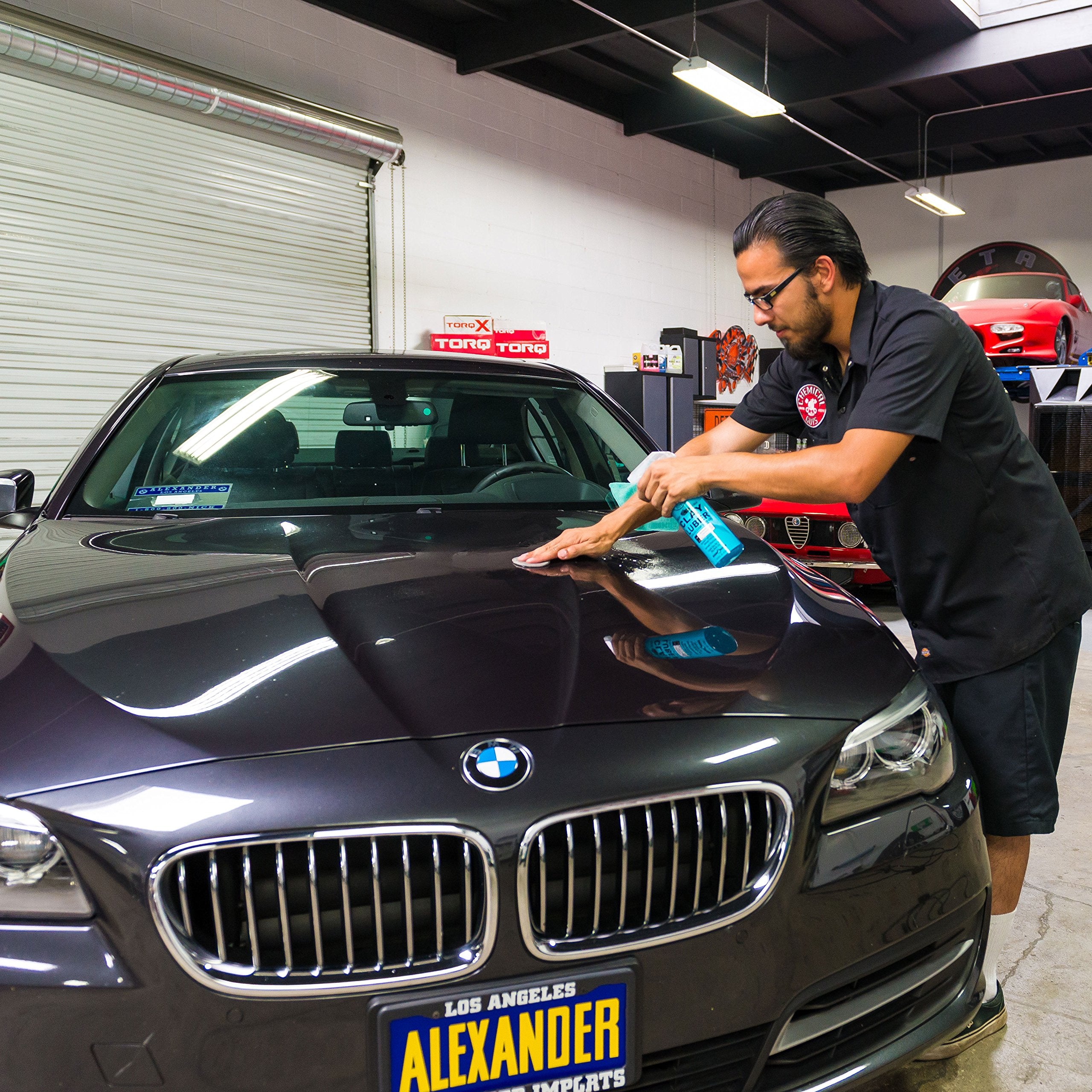Chemical Guys clay bar in use on car door for smooth finish