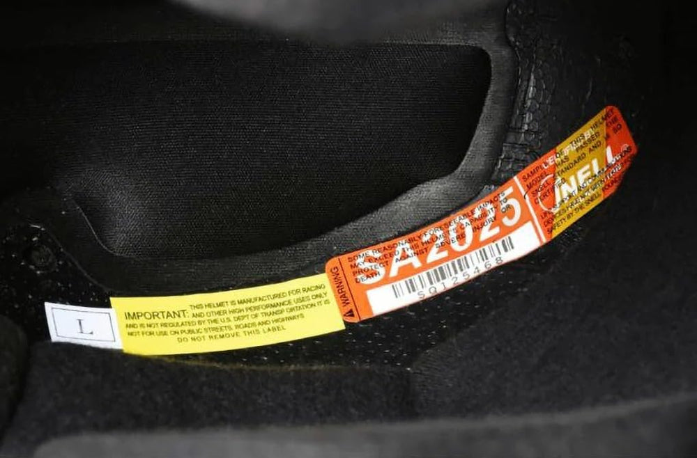 Conquer helmet Snell SA2025 certification label proving race-safety compliance
