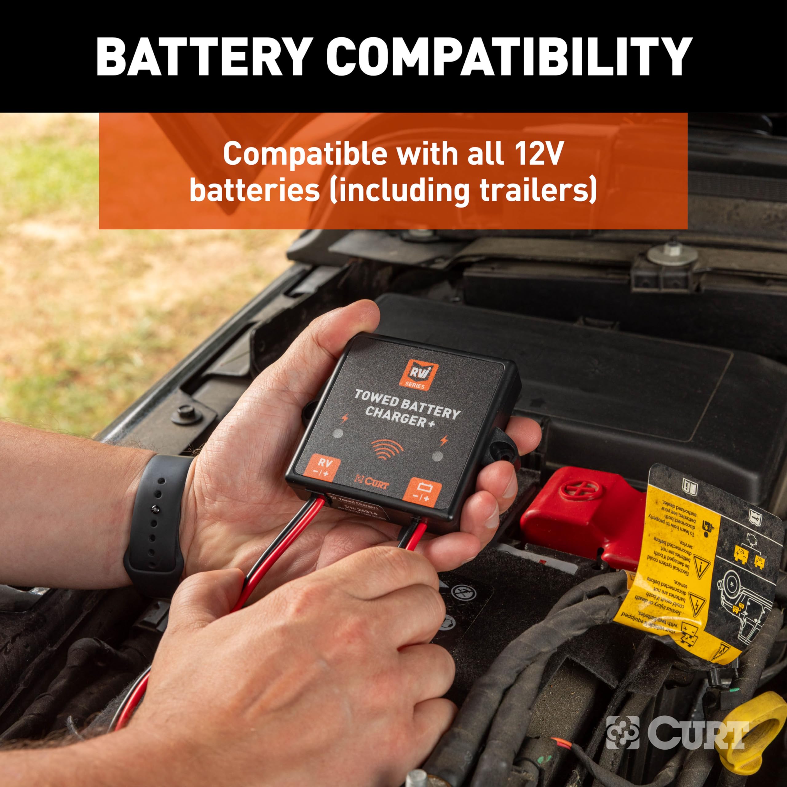 CURT charger in hand for size comparison showing compact design and portable convenience