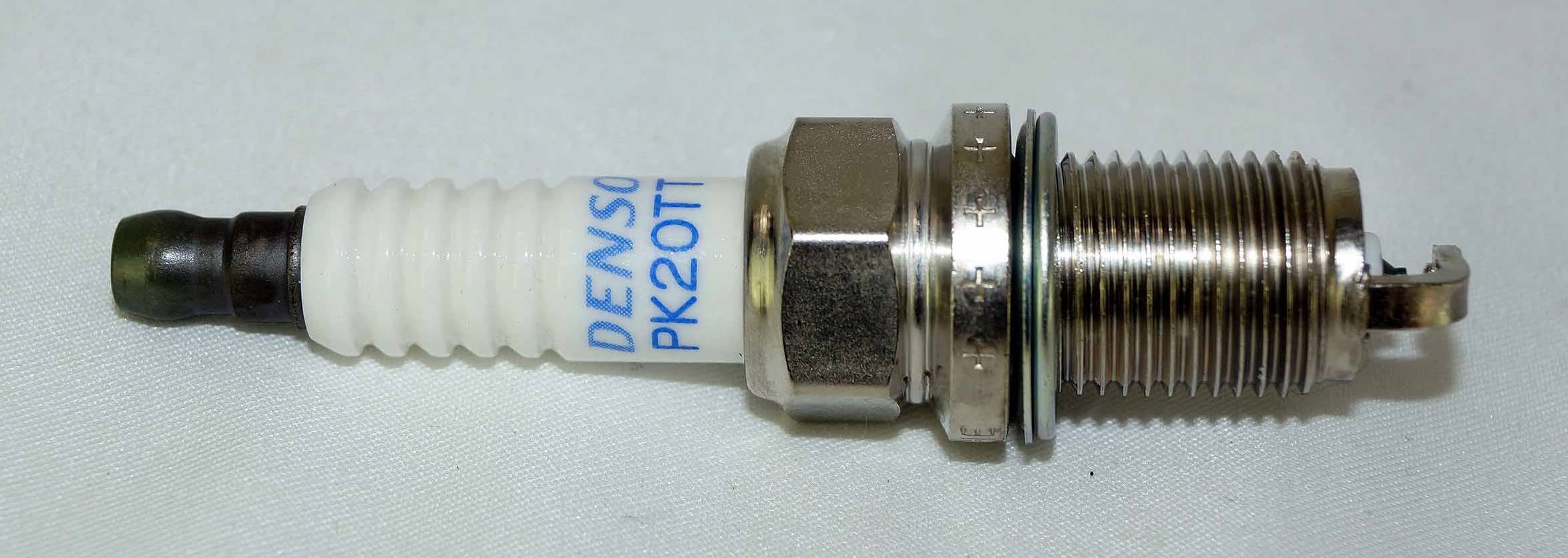 Denso PK20TT ground electrode detail showing titanium-enhanced alloy advantage