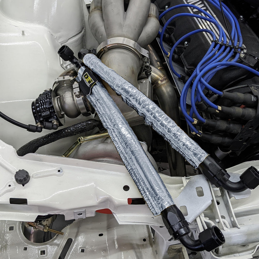 Design Engineering Heat Sheath slipped over engine hose in bay, reducing heat exposure