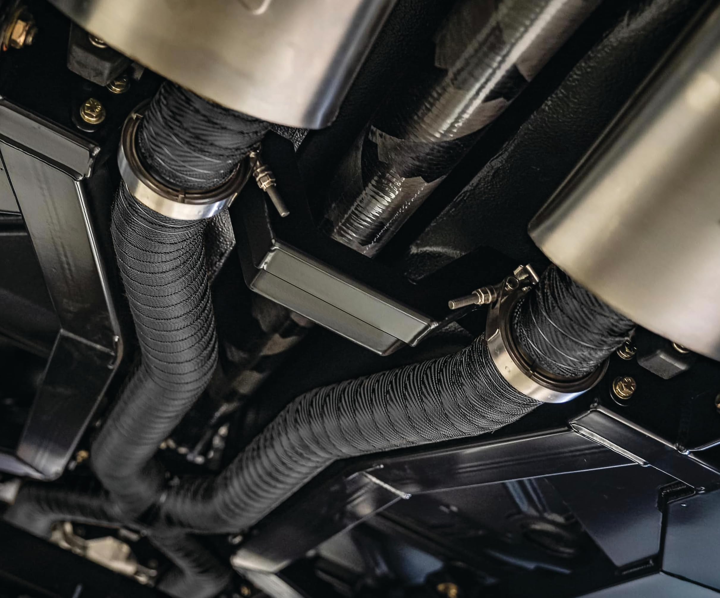 Design Engineering fully wrapped exhaust on vehicle, highlights thermal protection benefit