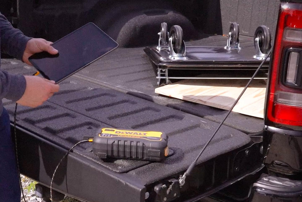 DEWALT powering phone and tablet simultaneously showing multi-device convenience