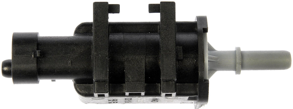 Dorman purge valve beside a coin for scale showing compact direct-fit size