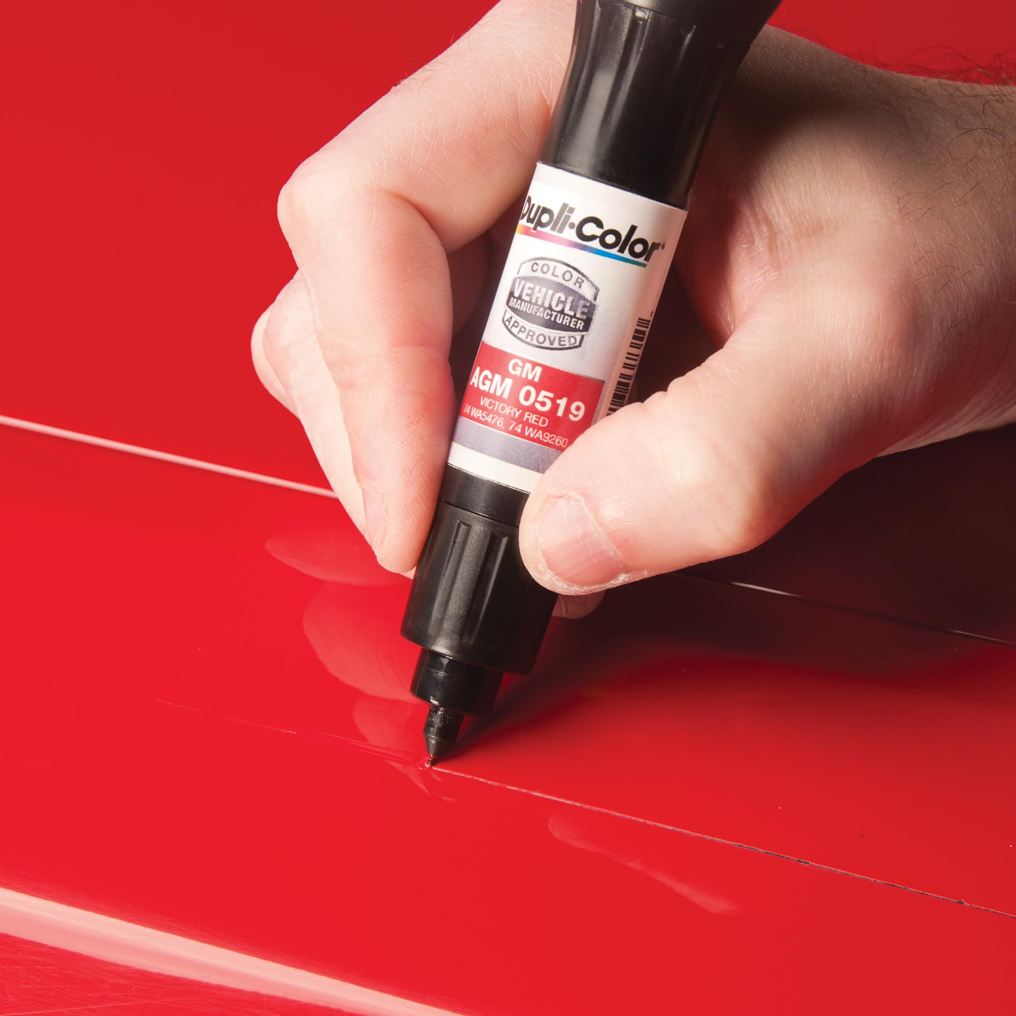 Dupli-Color touch-up next to a coin illustrating compact size for convenient storage