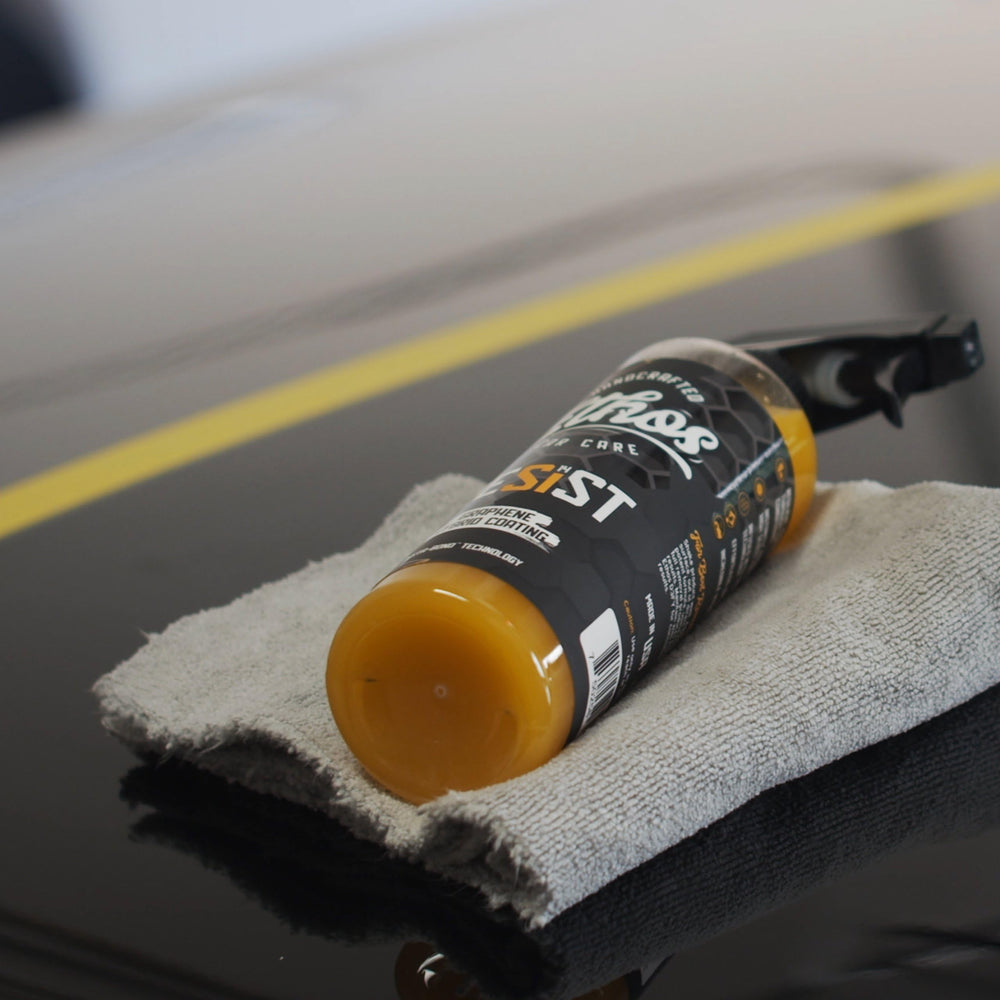 Ethos Handcrafted Car Care spraying product onto panel demonstrating easy application benefit