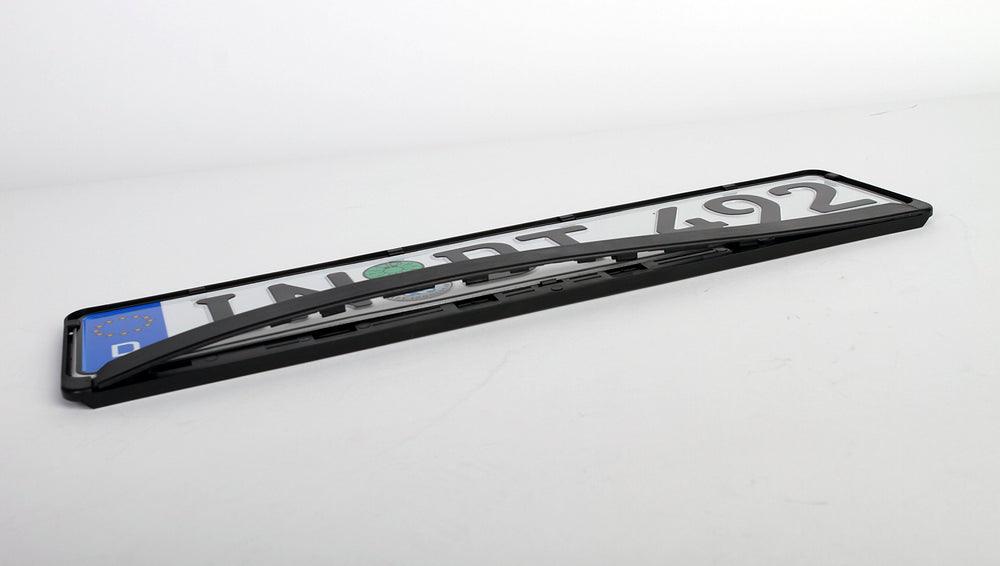 European License Plates on a car in motion showing stable mounting and road resilience