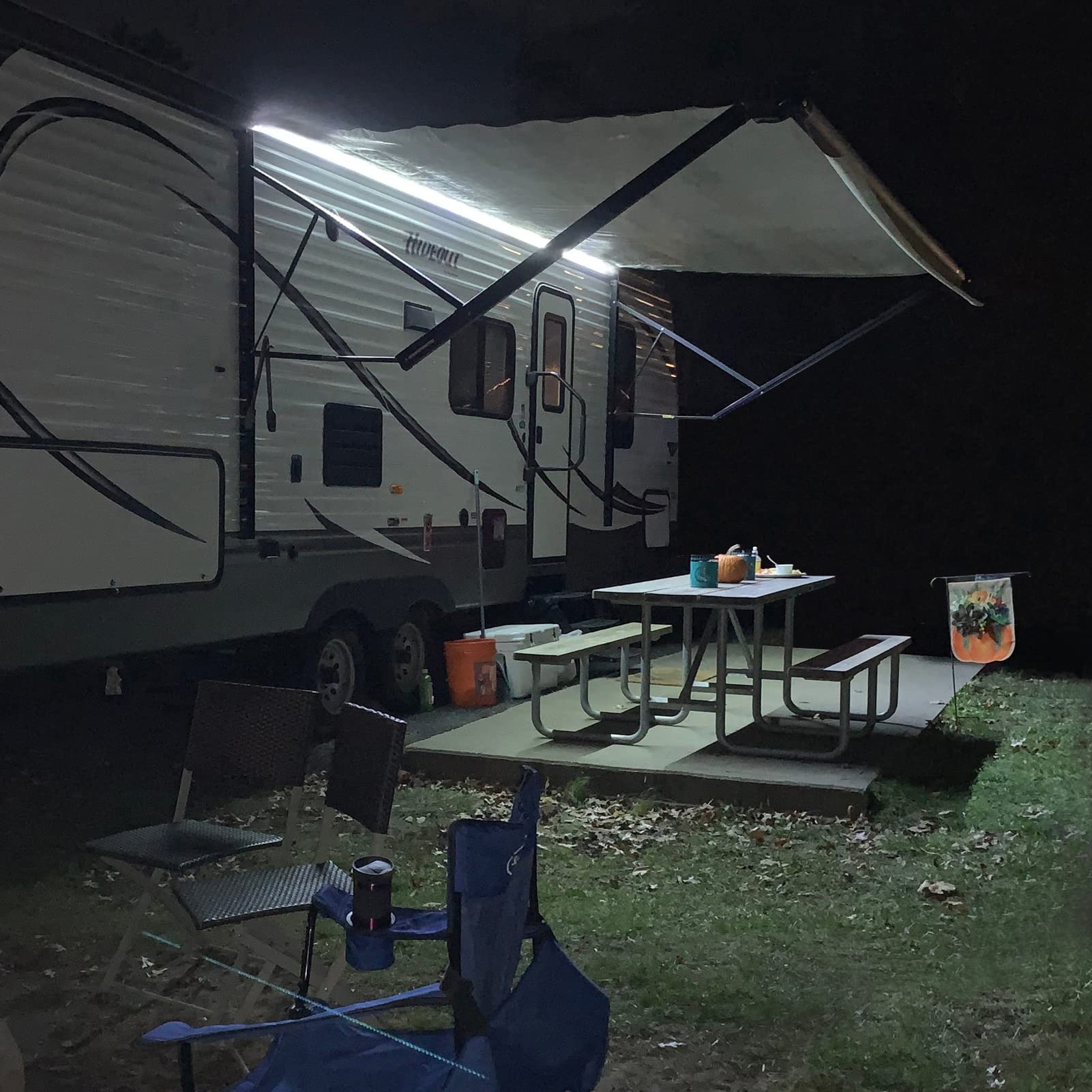 EXCELFU lifestyle shot with family BBQ showing warm, adjustable outdoor ambiance