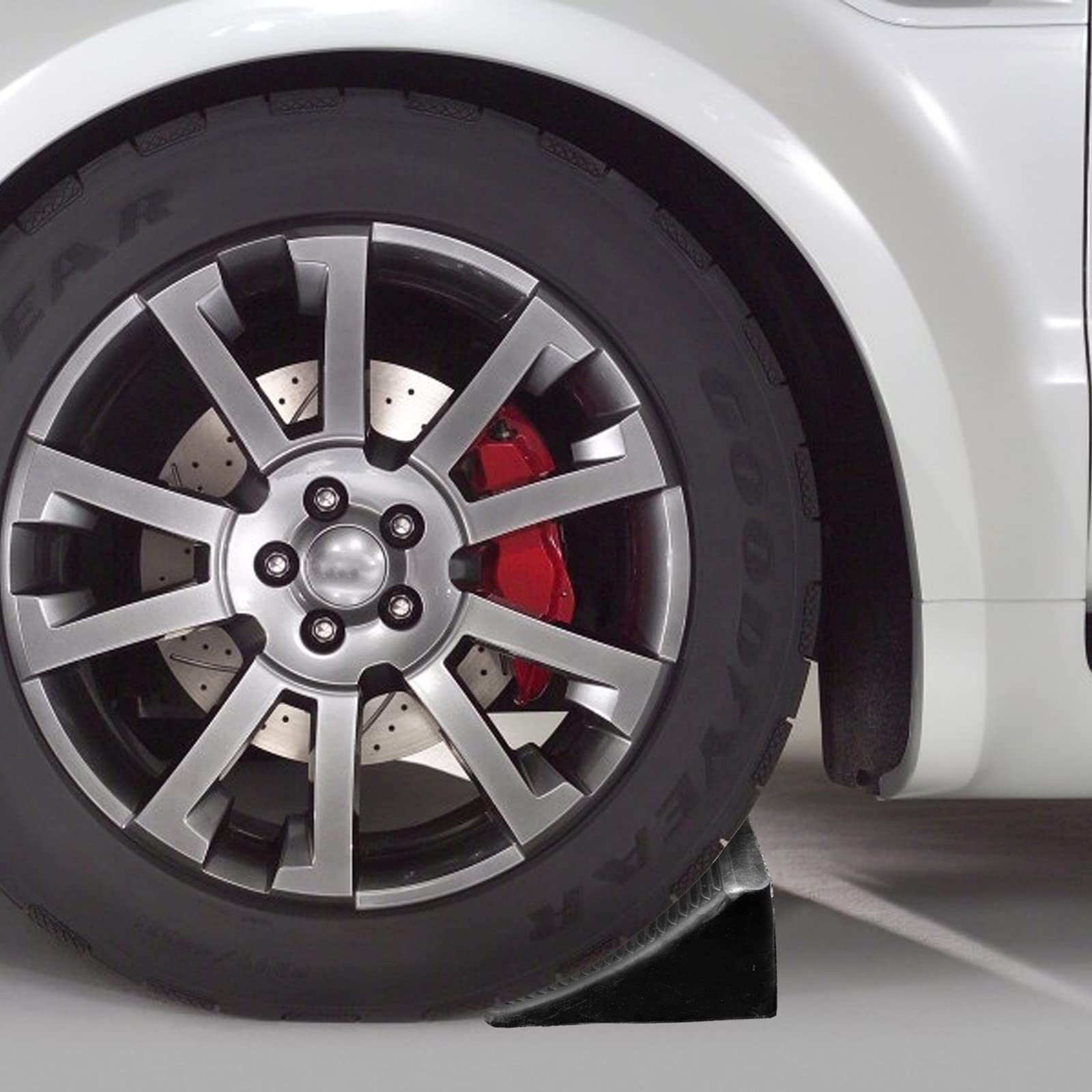Fasmov chock in use against trailer tire preventing roll during hitching benefit