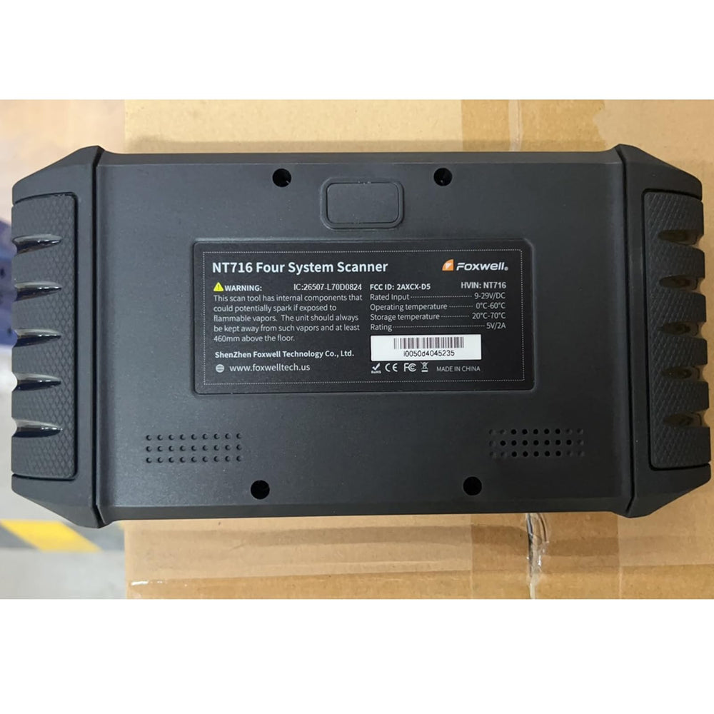 FOXWELL NT716 next to a hand for scale to show portable, tablet-sized convenience