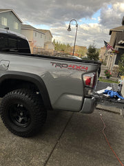 GO-GO.GROUP decal installed on pickup bedside demonstrating seamless paint match