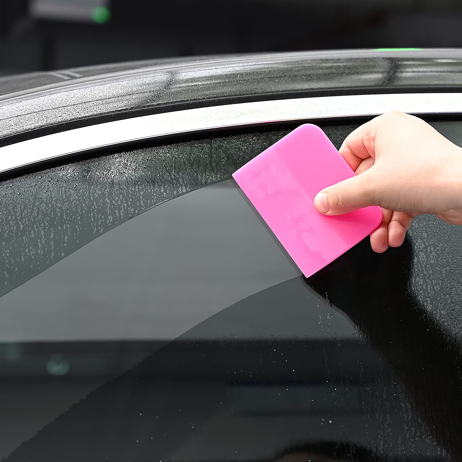 Gomake squeegee smoothing vinyl on car door during wrap install, reduces bubbles