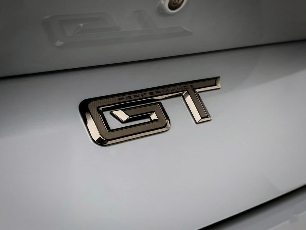Generic GT badge close-up texture gloss black highlighting durable ABS finish