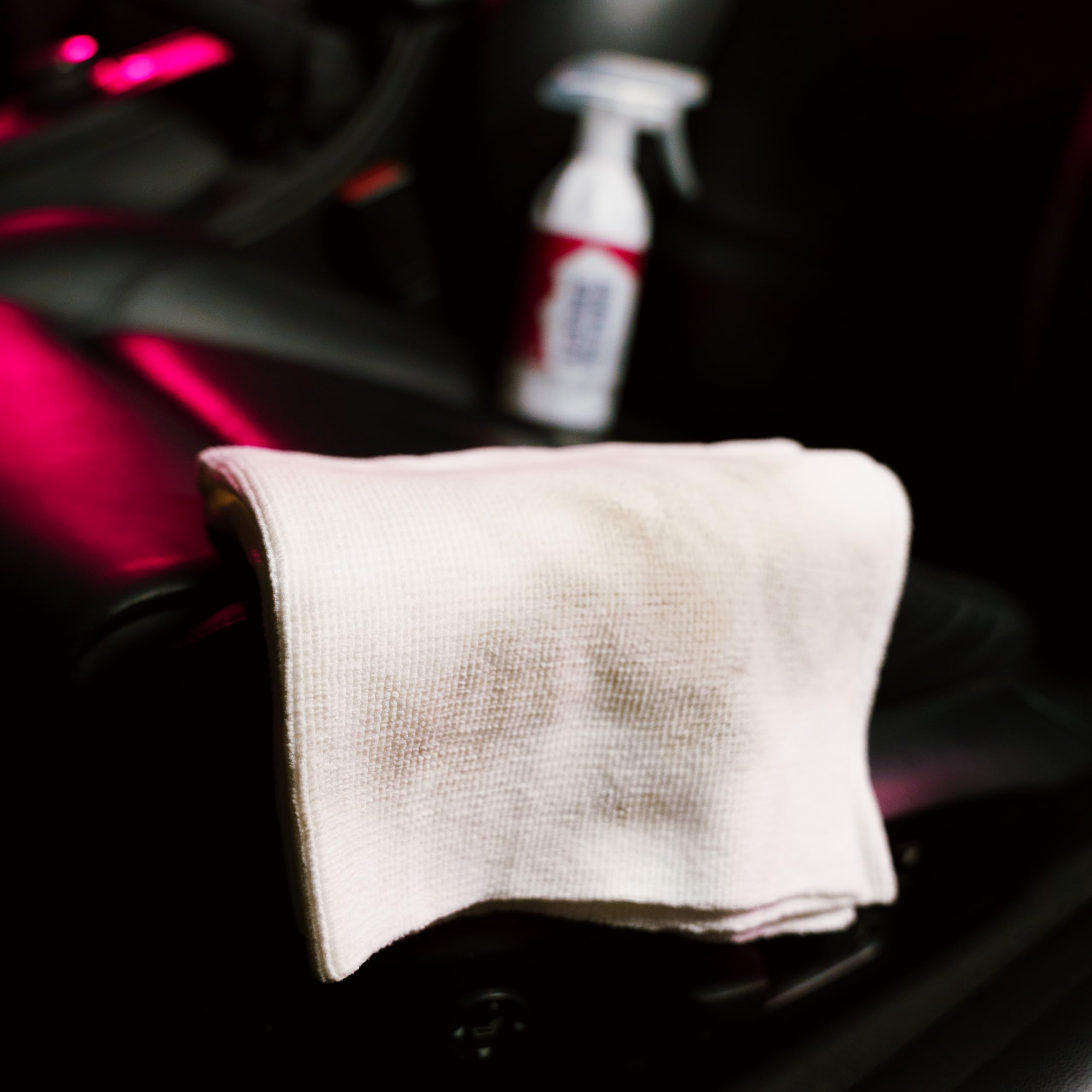 Microfiber applicator applying Gyeon to leather for efficient prep