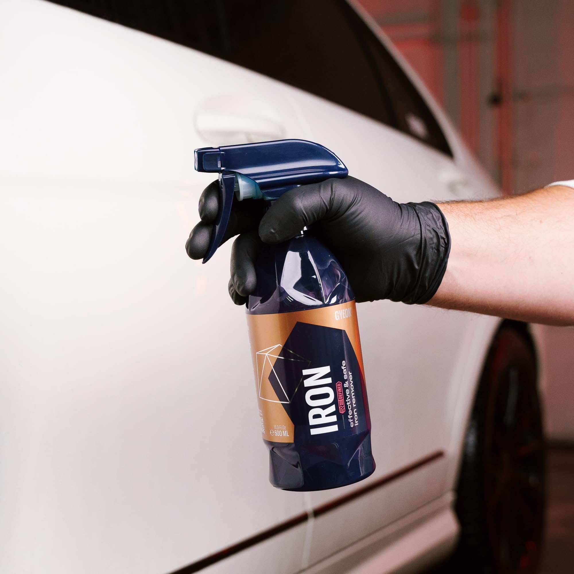 Technician spraying GYEON in garage lifestyle scene for professional results