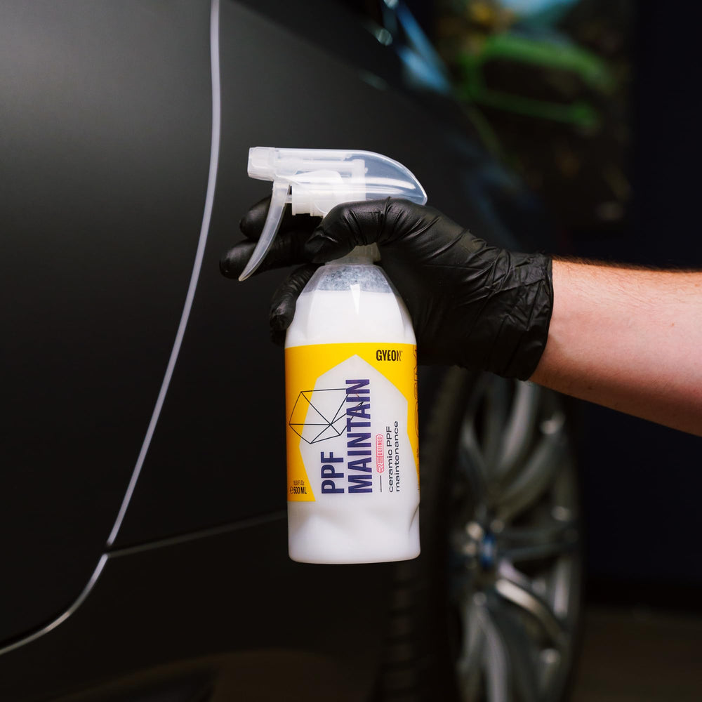 Gyeon car in showroom illustrating maintained film clarity and protection benefit