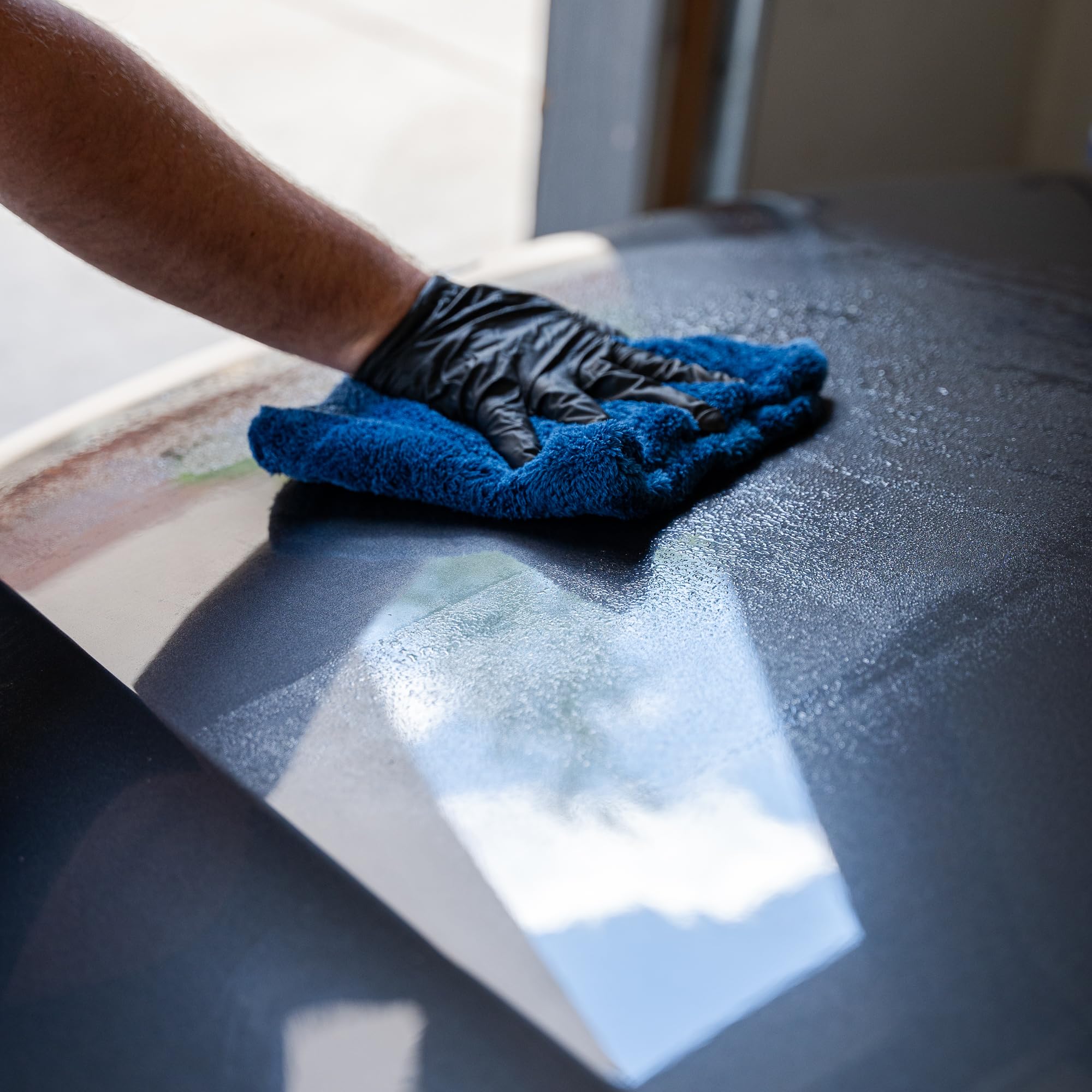 Gyeon Prep cleaning glass and trim demonstrating safe multi‑surface use