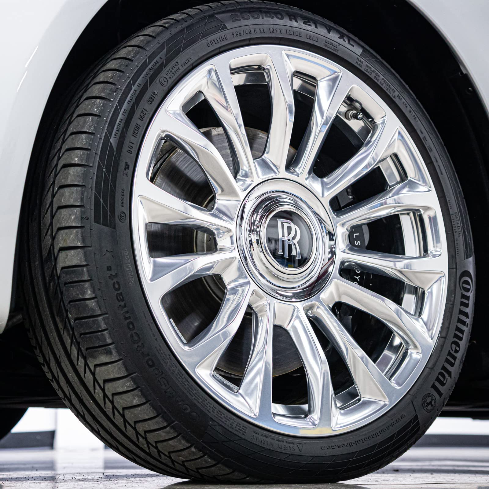 Lifestyle shot of car with Gyeon Rim–treated wheels parked on a clean driveway