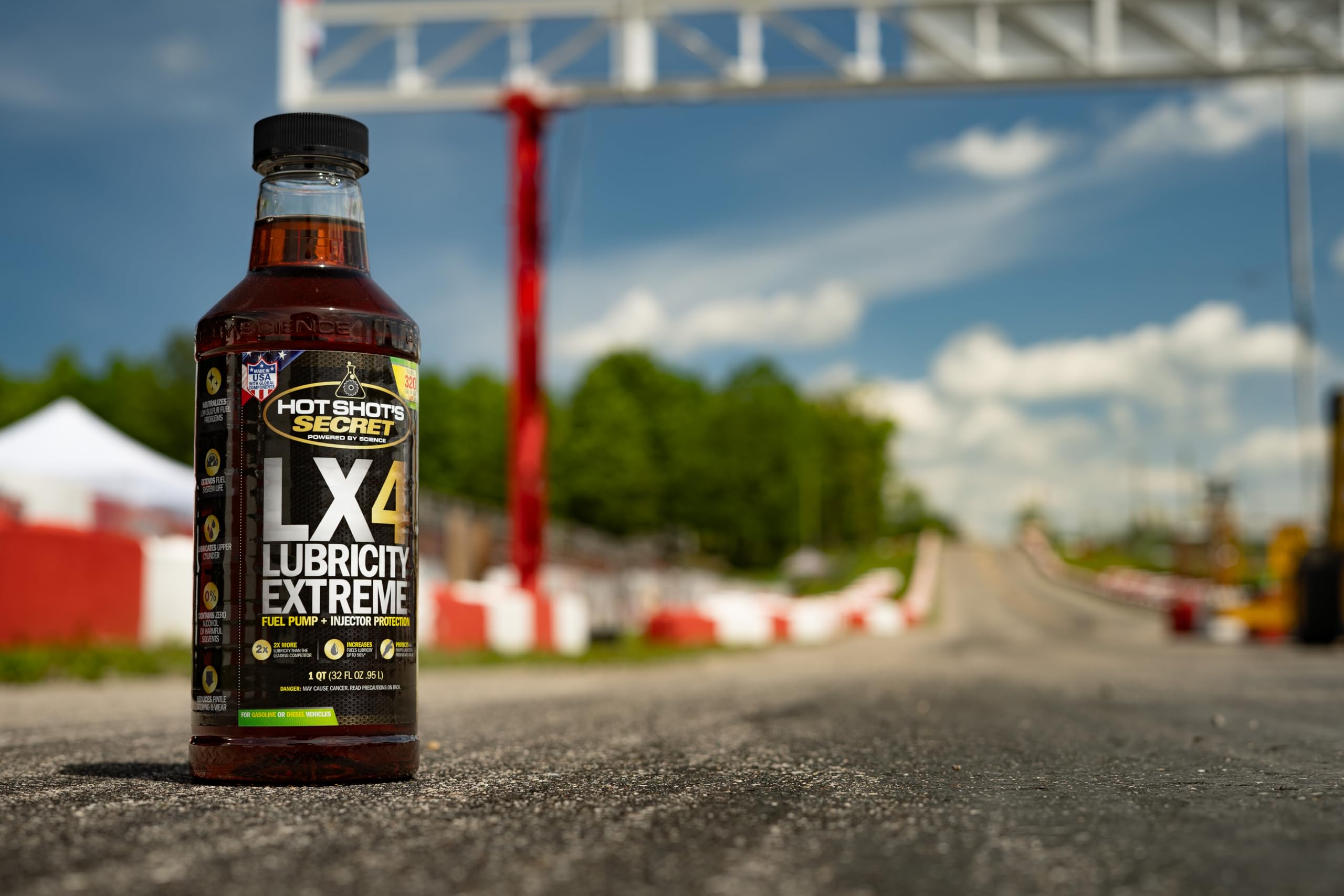 Hot Shot's Secret LX4 in a garage with a pickup truck showing practical vehicle care