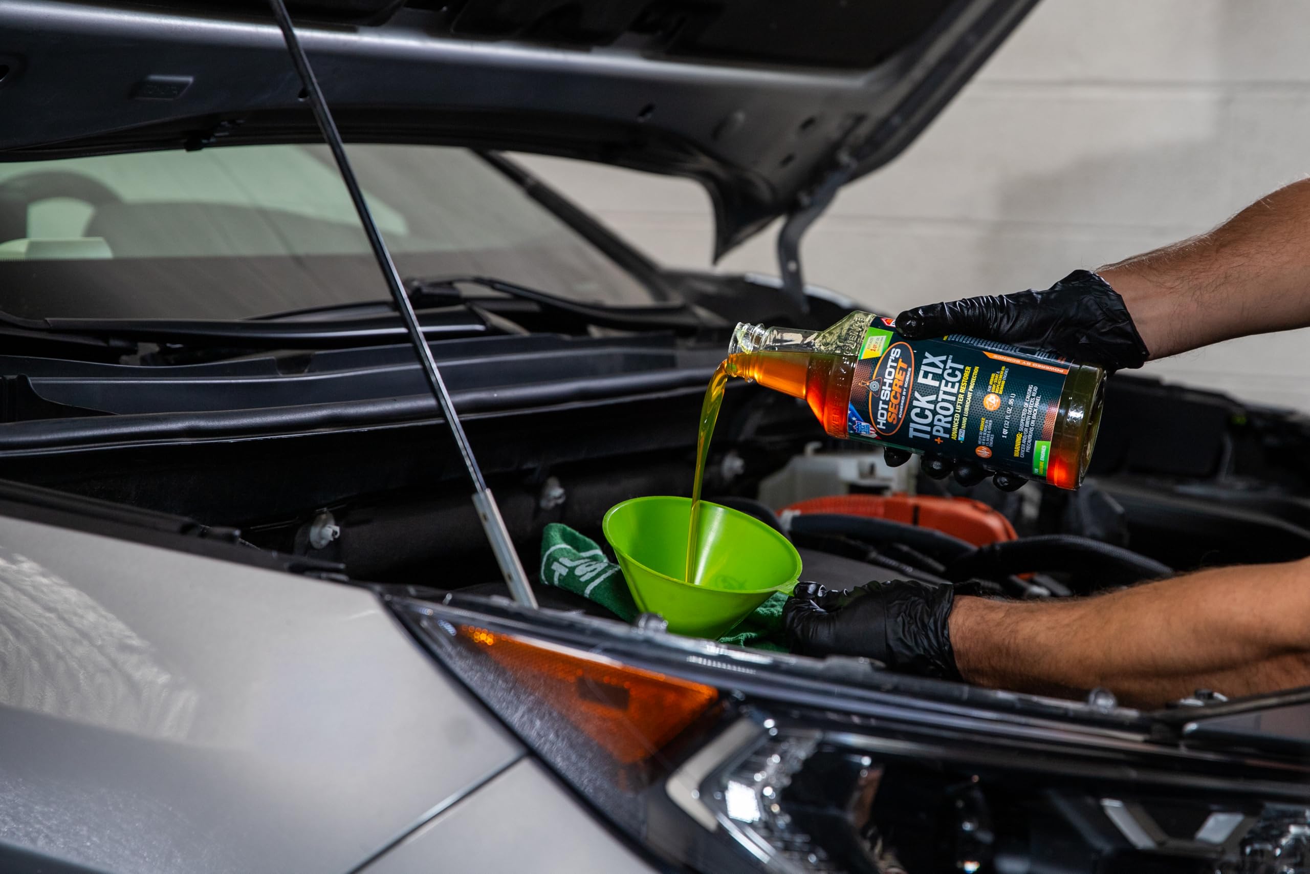 Hot Shot's Secret 32 oz bottle next to oil filter showing compact convenient size