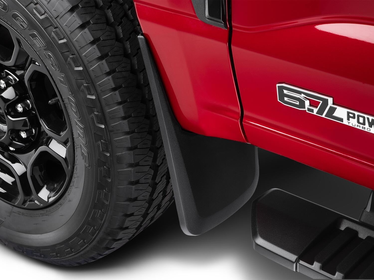 Husky Liners mud guard next to ruler showing precise, vehicle-specific sizing