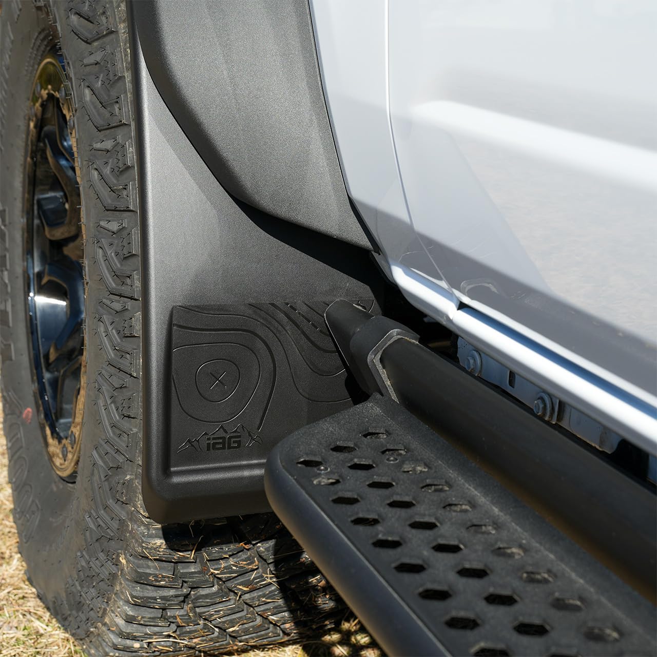 IAG Performance mud flap beside ruler showing adjustable width and scale