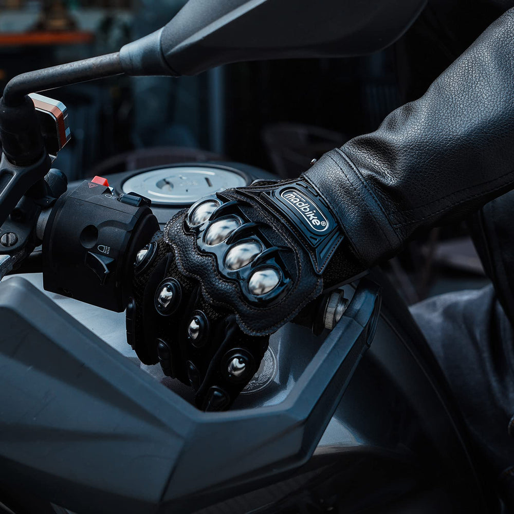 ILM gloves worn while riding a dirt bike illustrating protection and control in action