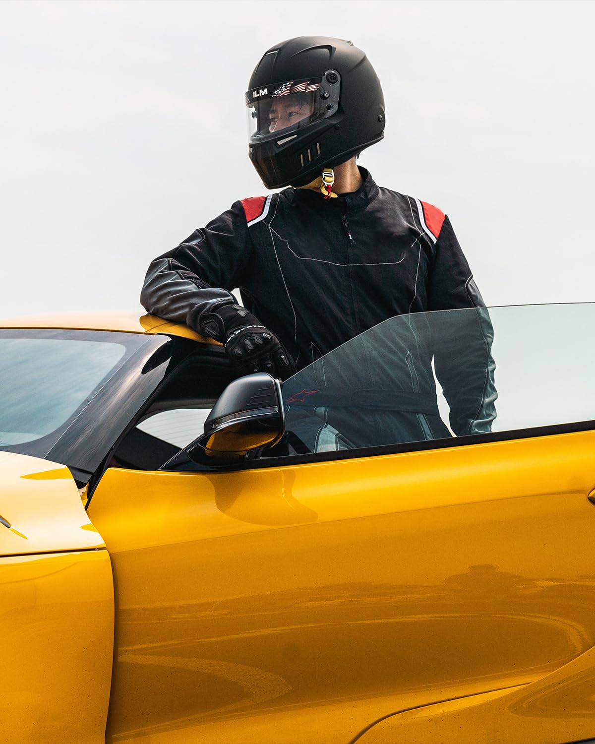 ILM helmet held in hand to show size and lightweight fiberglass composite feel