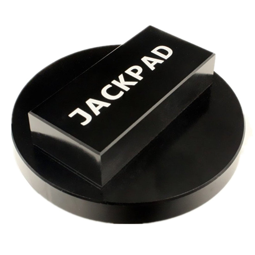 imUfer jack pad in a garage setting used during routine wheel maintenance