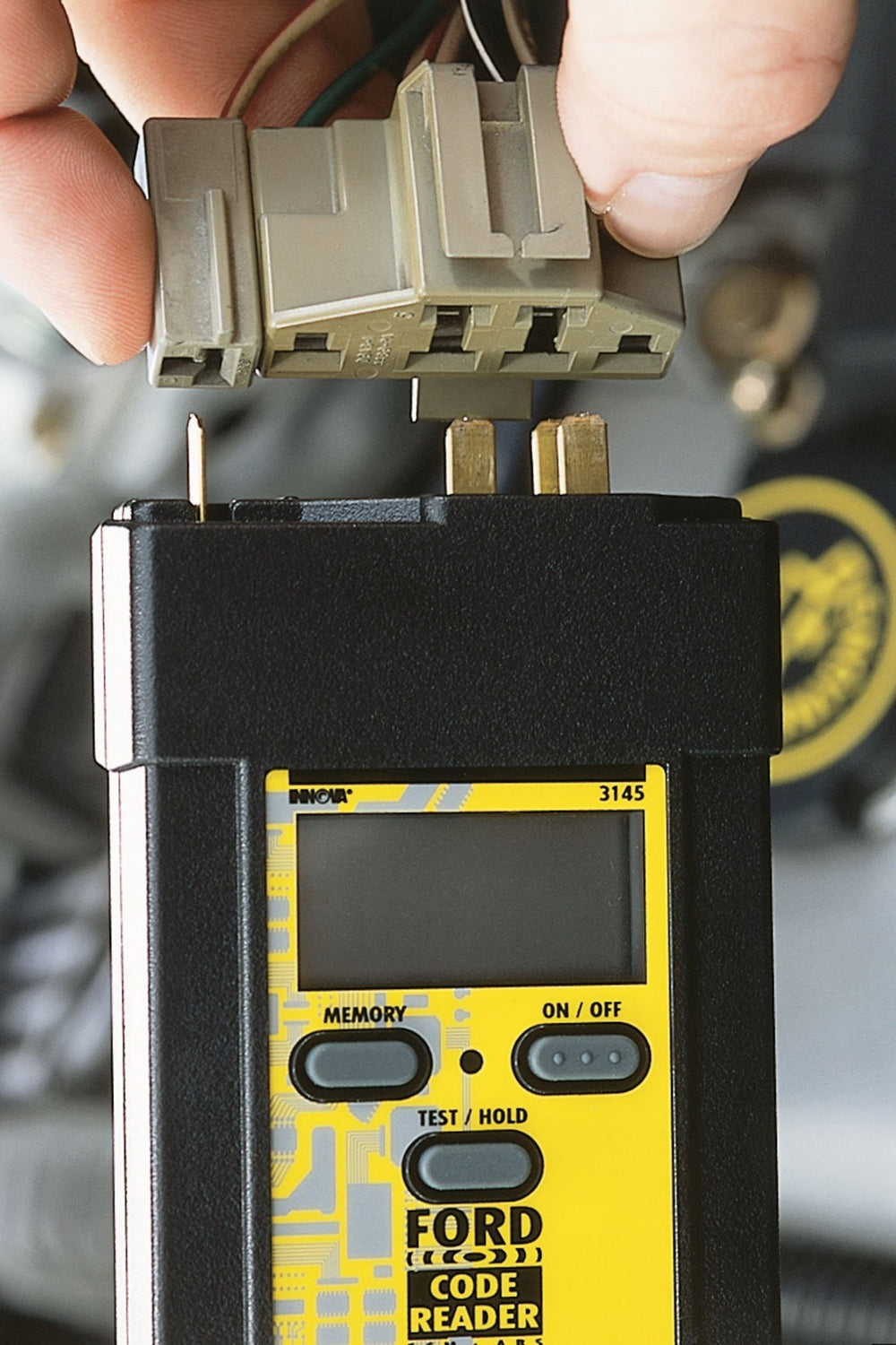 Innova 3145 digital display closeup showing numeric trouble codes for fast identification