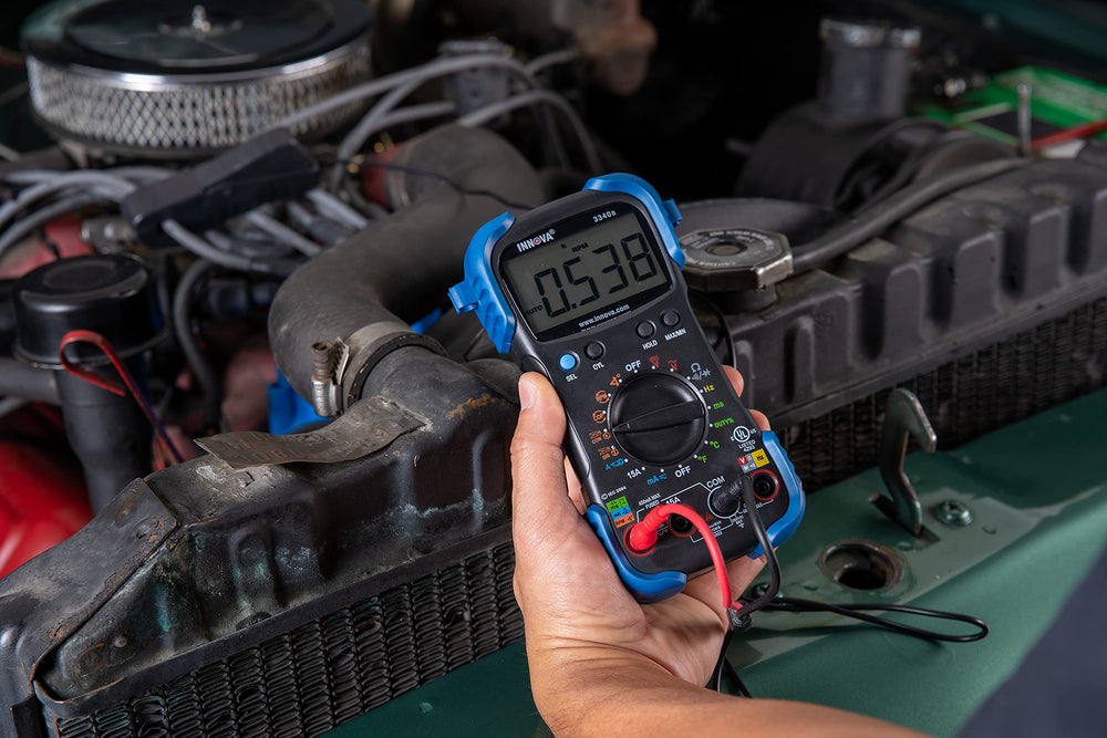 Innova 3340 next to a hand to show compact, portable scale