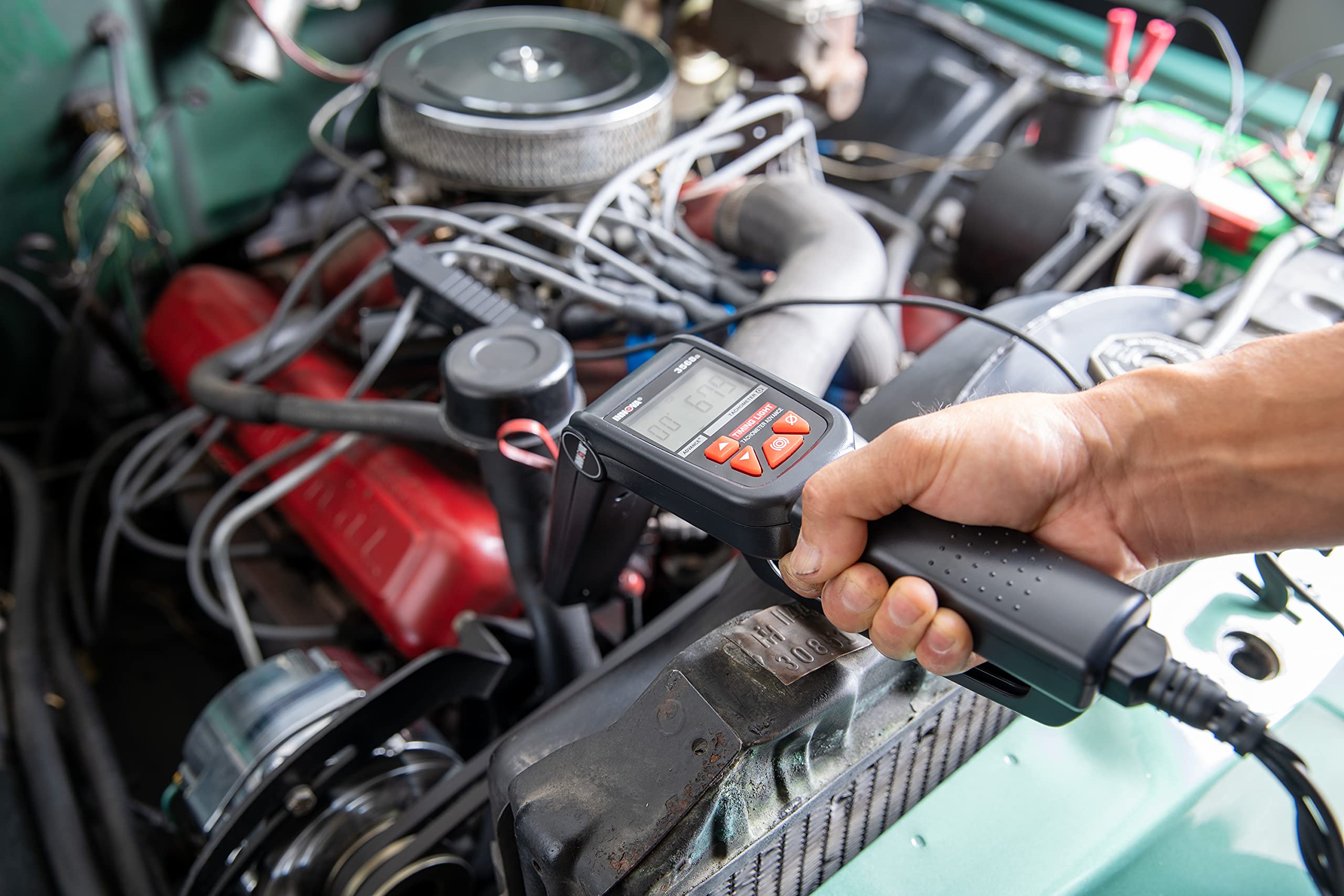 Innova in-use in engine bay demonstrating quick timing checks during tuning