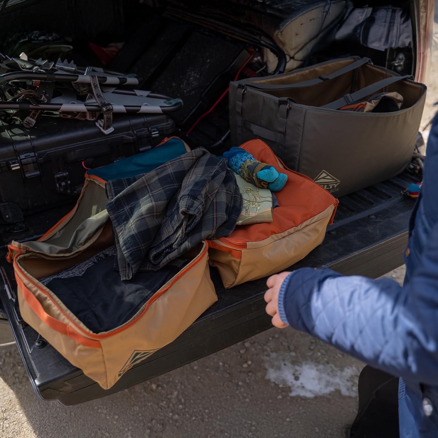 Kelty cargo box next to a water bottle showing scale and practical packing capacity