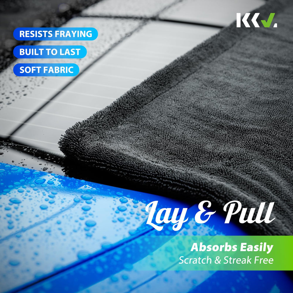 KKV towel held in hand to show 36x24 inch scale and easy handling benefit