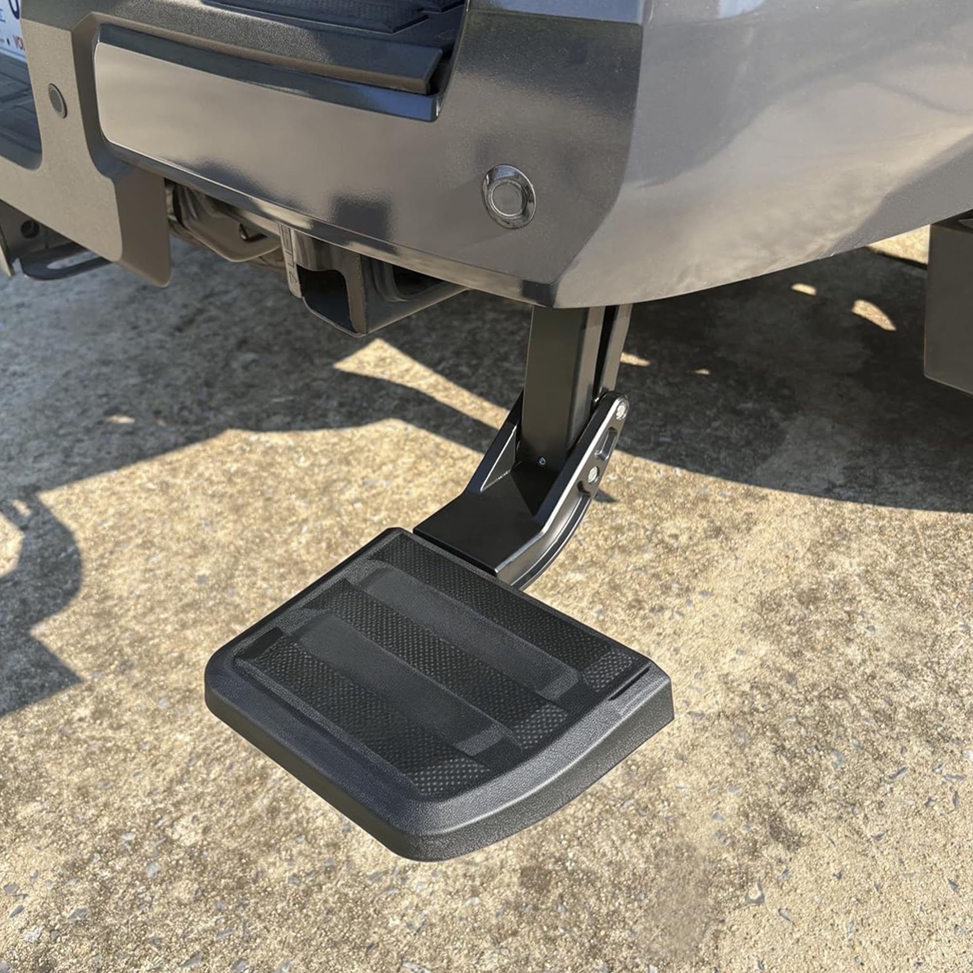 KLN tailgate step size comparison with hand to show compact scale