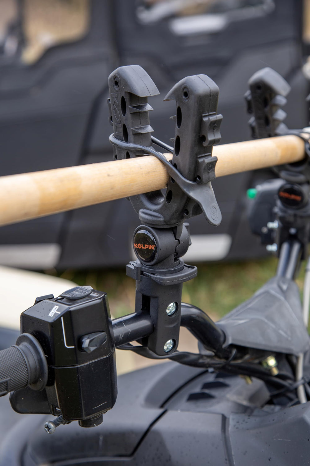 Kolpin Rhino Grip XL holding a gun and bow illustrating dual-item carrying capability