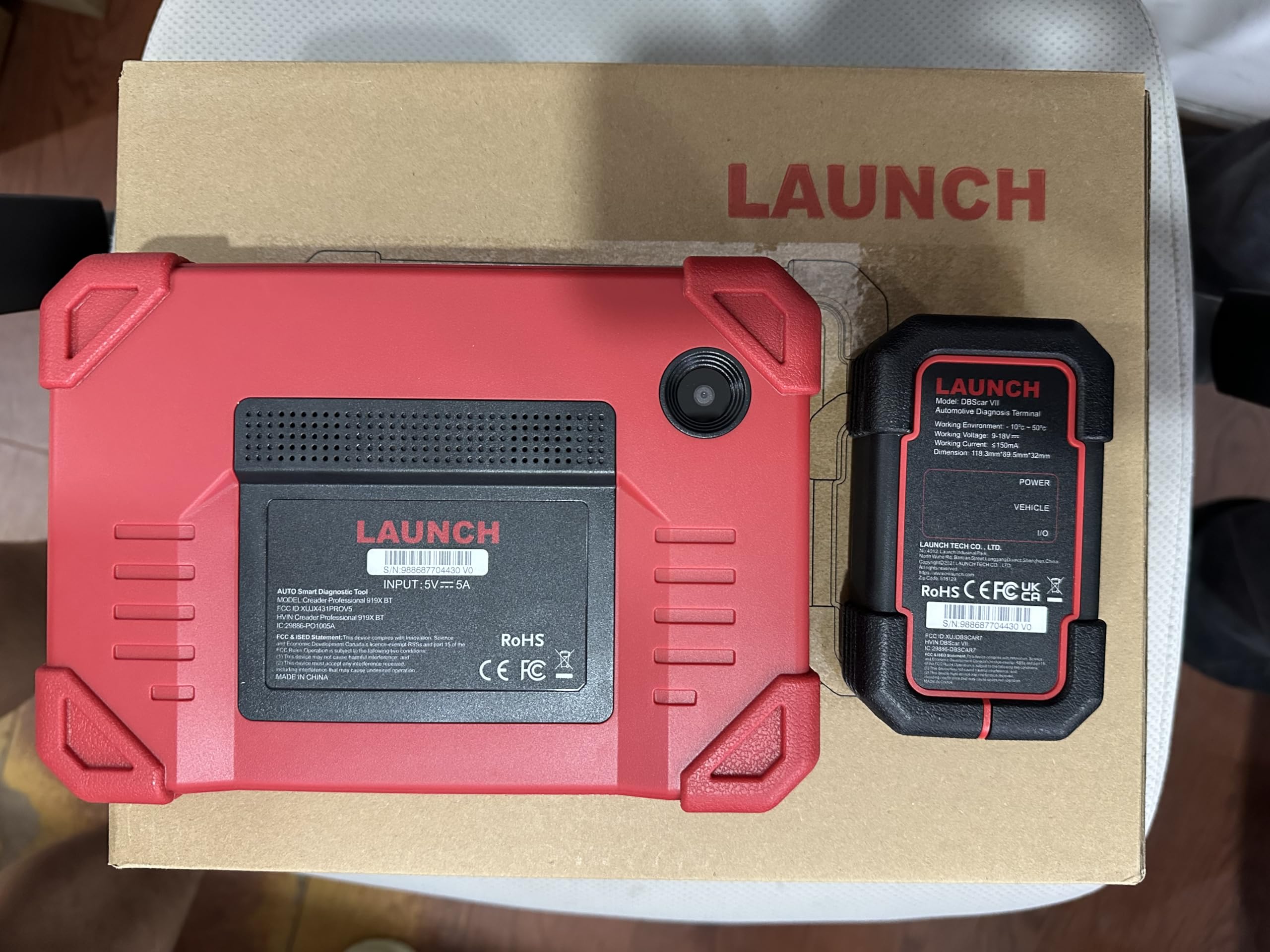 LAUNCH tablet next to car key showing compact scale and portability advantage