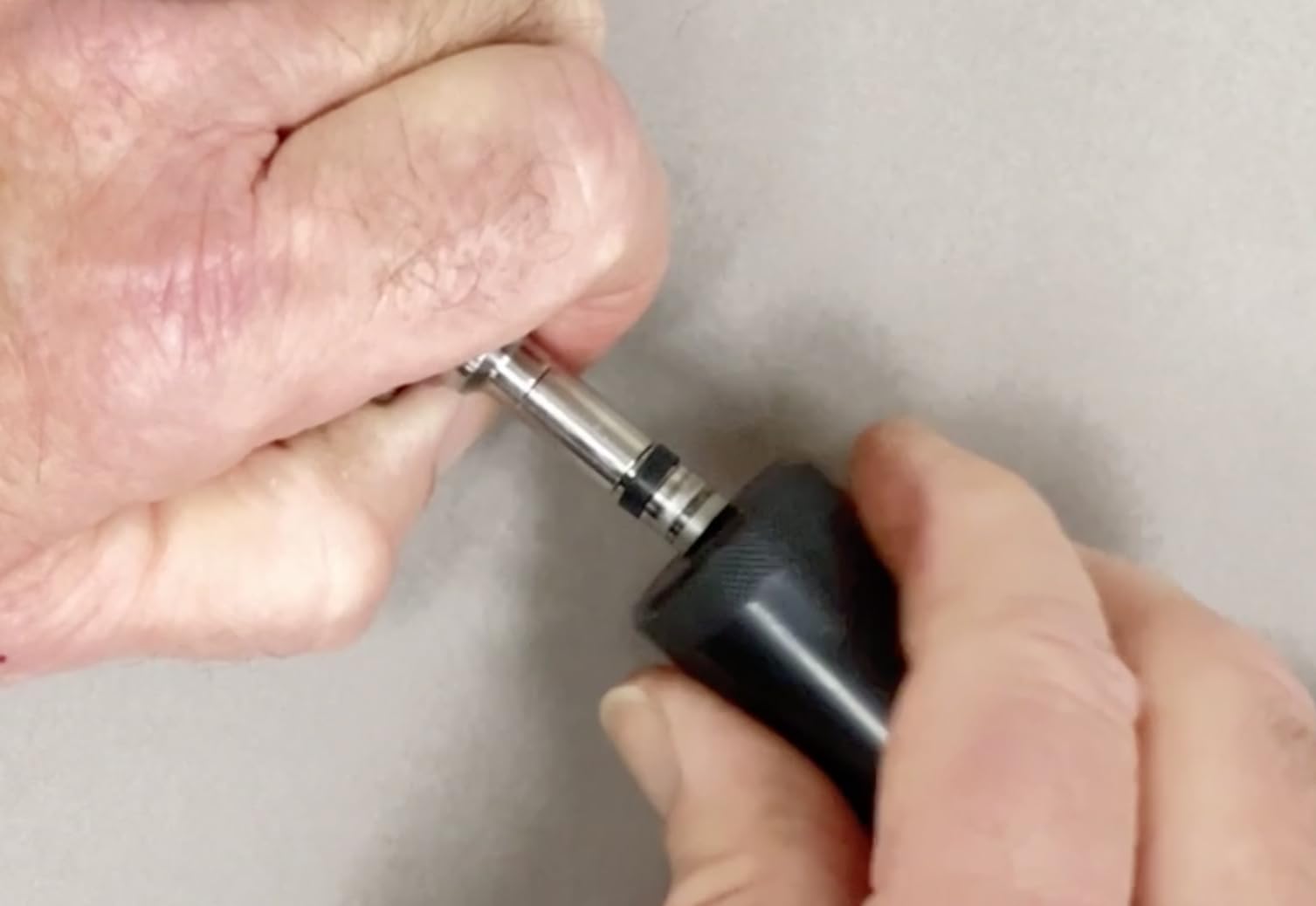 Lisle close-up of pilot cone and sizer on injector tip demonstrating precise seal alignment