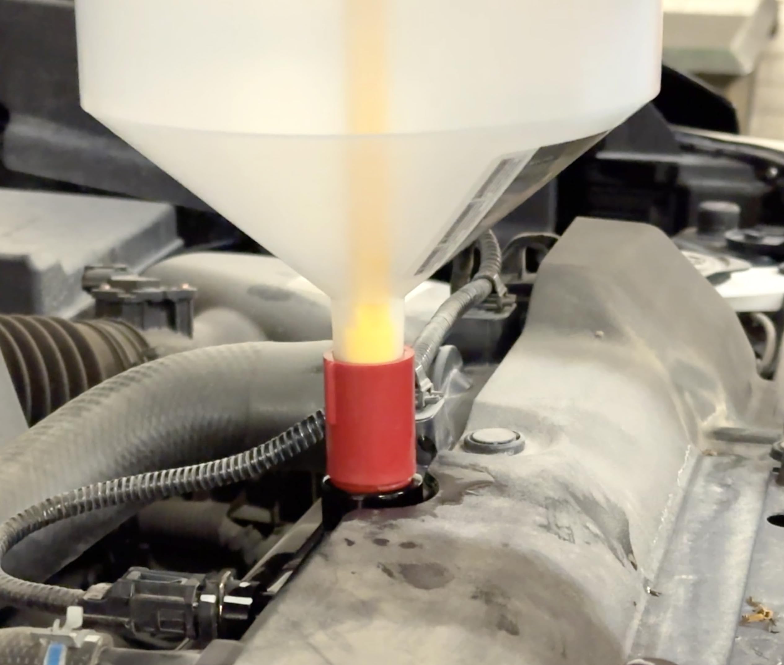 Lisle funnel kit installed in engine bay demonstrating spill-free coolant filling advantage