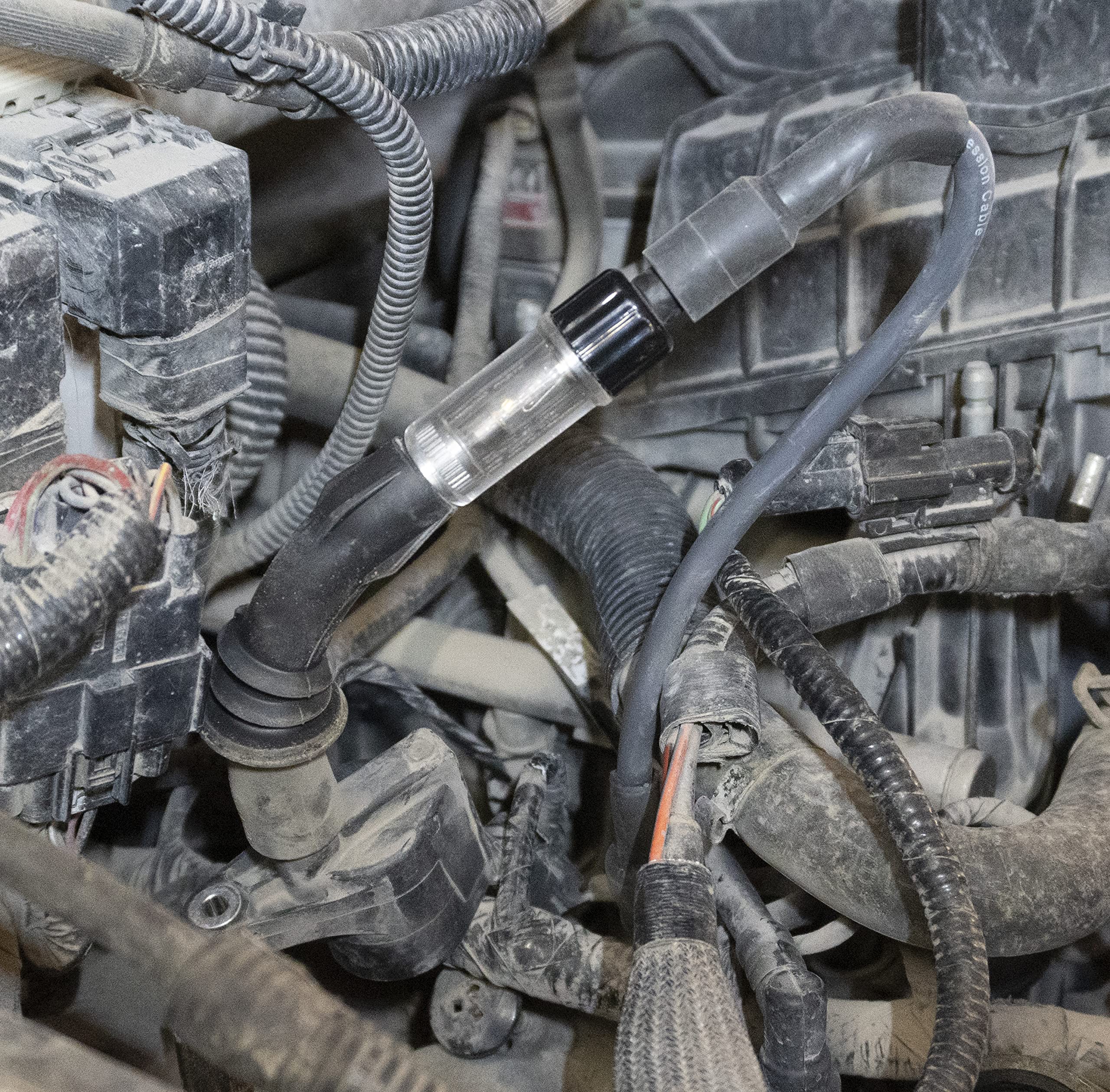Lisle tester in engine bay with extension reaching recessed coil benefit