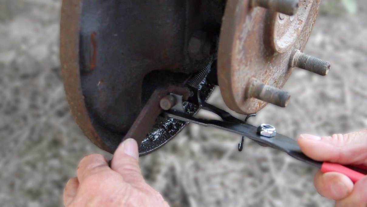 Lisle tool compressing brake cable spring in use saves time and effort