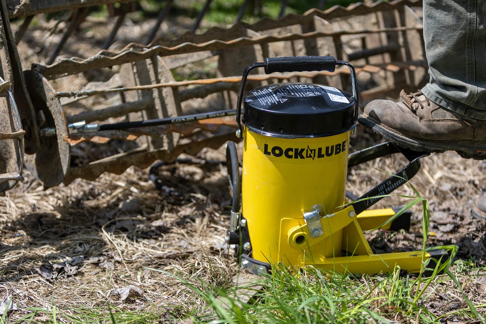 LockNLube greasing a tractor joint showing efficient farm equipment maintenance benefit