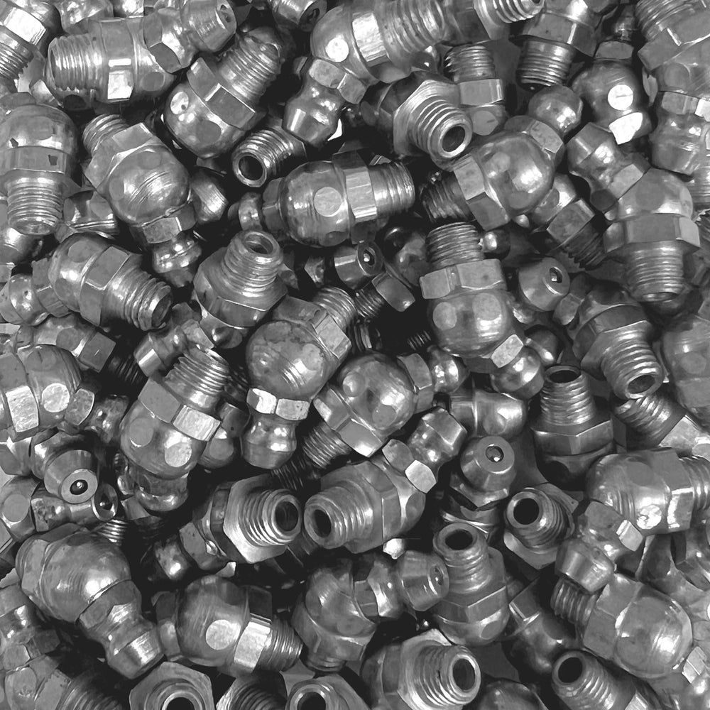 LockNLube fittings in hand for scale showing compact kit portability benefit