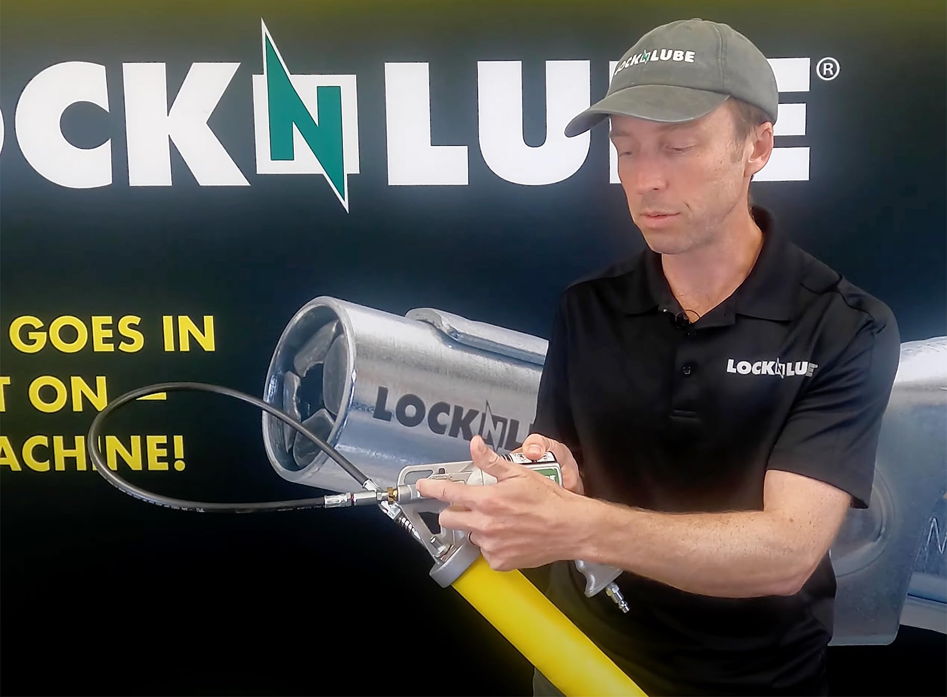LockNLube grease gun held in hand showing size and ergonomic handling benefit