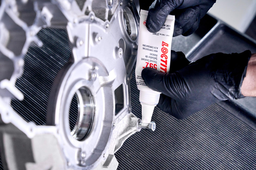 Loctite 592 beside a wrench for scale showing compact 50 ml size advantage